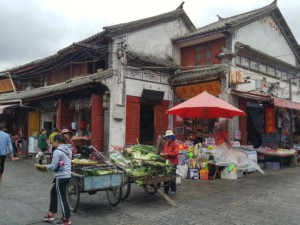 Street vendors in front of butcher shop